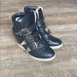 Black wedged studded sneakers.